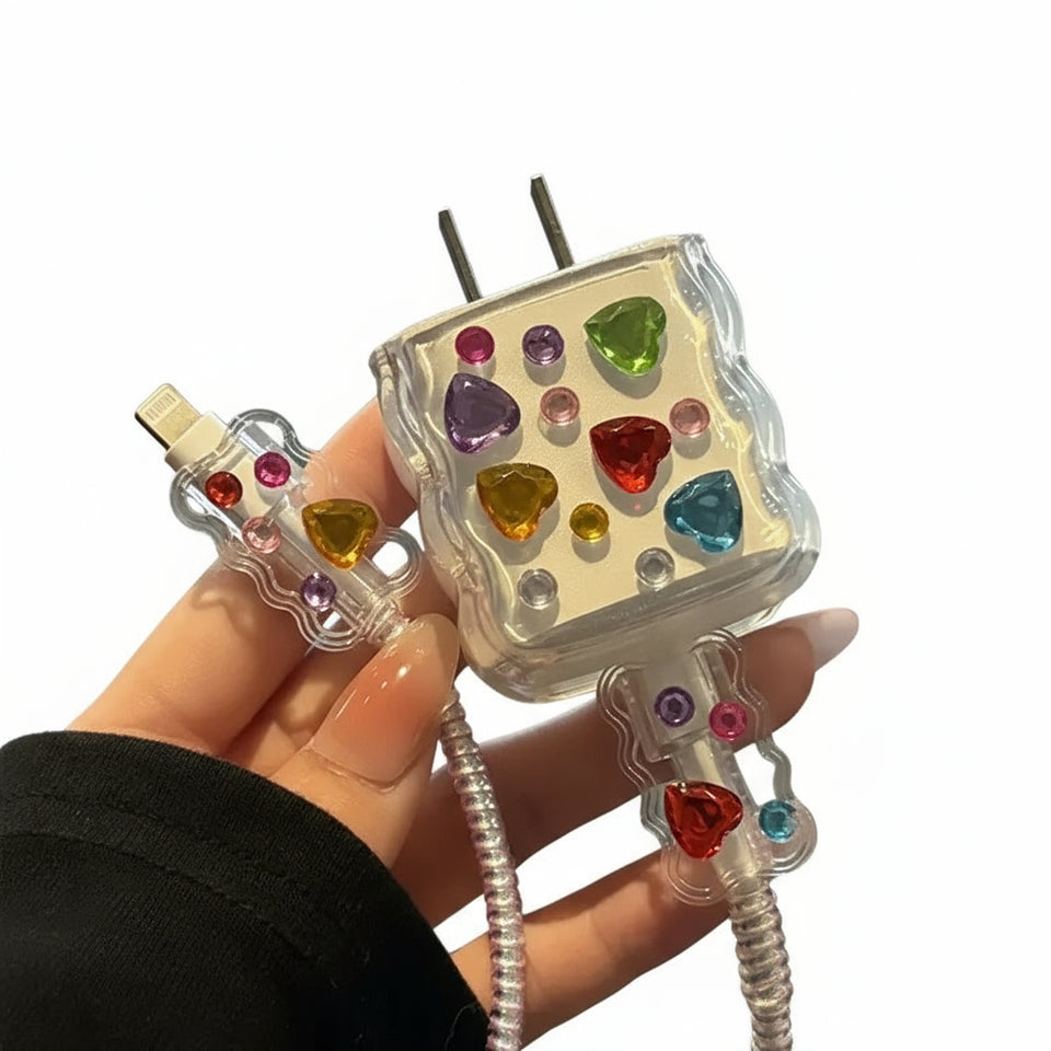 Colorful gemstone-studded phone charger held by a hand