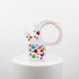 Decorative phone charger with colorful gemstones on a white background