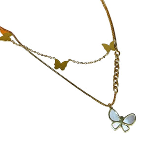 Gold butterfly necklace on a white background