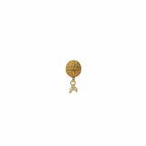 Gold earring on a black stand with a blurred background