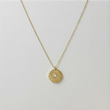 Gold necklace with a circular pendant 