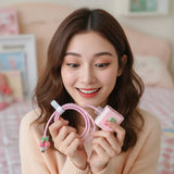 Pink charging cable and adapter with cherry design on a checkered background