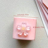 Pink square object with a flower design and measurements on a light gray background