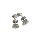 Silver earrings on a black fabric background