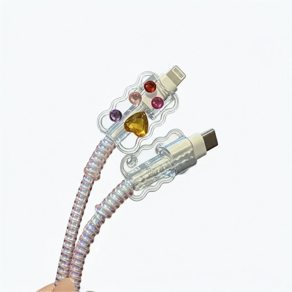 Transparent cable with colorful gemstones on a gray surface