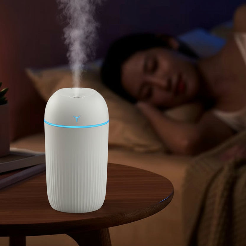 Humidifier emitting steam with a person lying down in the background, labeled as a warm atmosphere lamp.